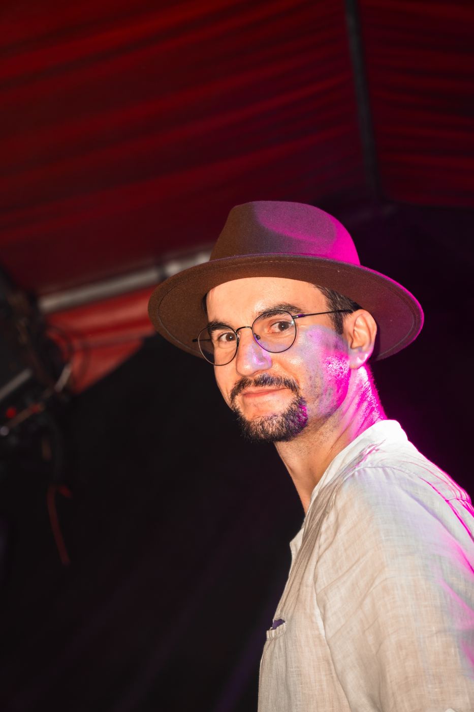 Portrait von Paul mit Hut im pink-violetten Licht